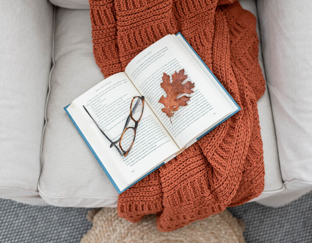 book with fall leaf and glasses