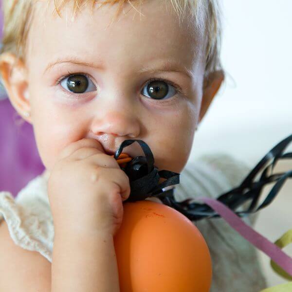 toddler chewing on an object