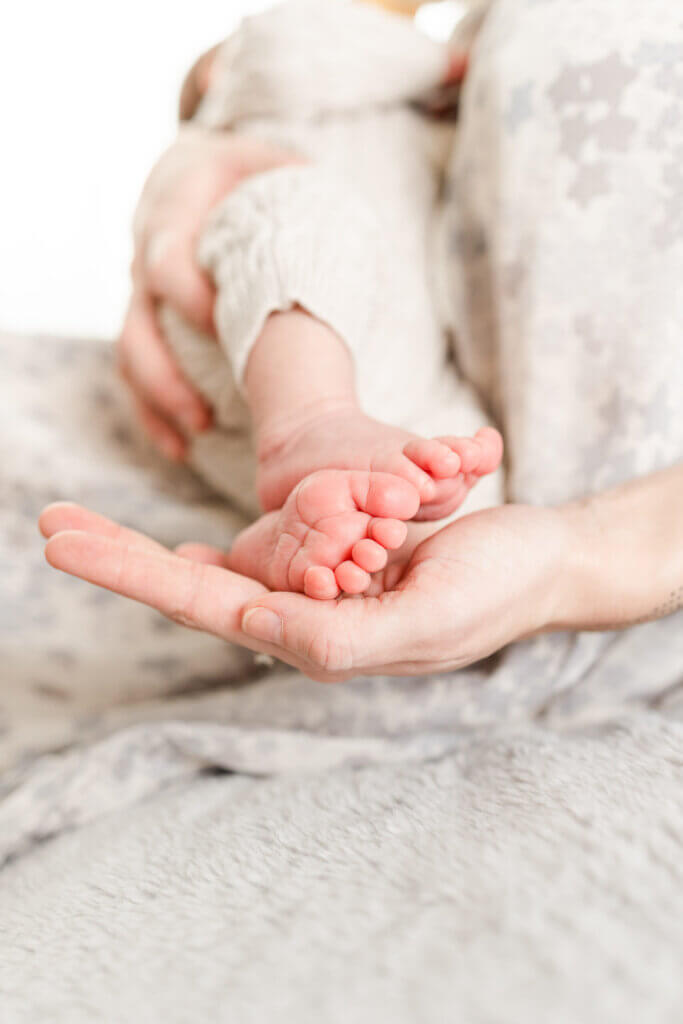 baby feet in mother's hand